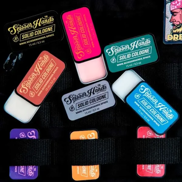 Scissor Hands solid colognes — a collection of compact fragrances in metal cases.